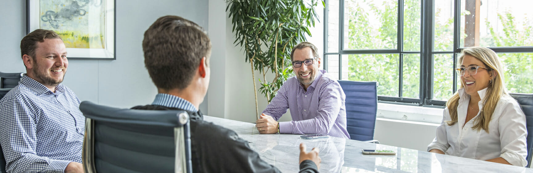 PSG Equity team members working around a table